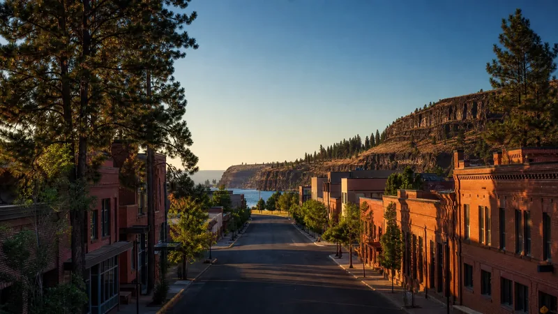 Inland Northwest river city street of brick buildings with pines and a basalt bluff, Spokane Business License